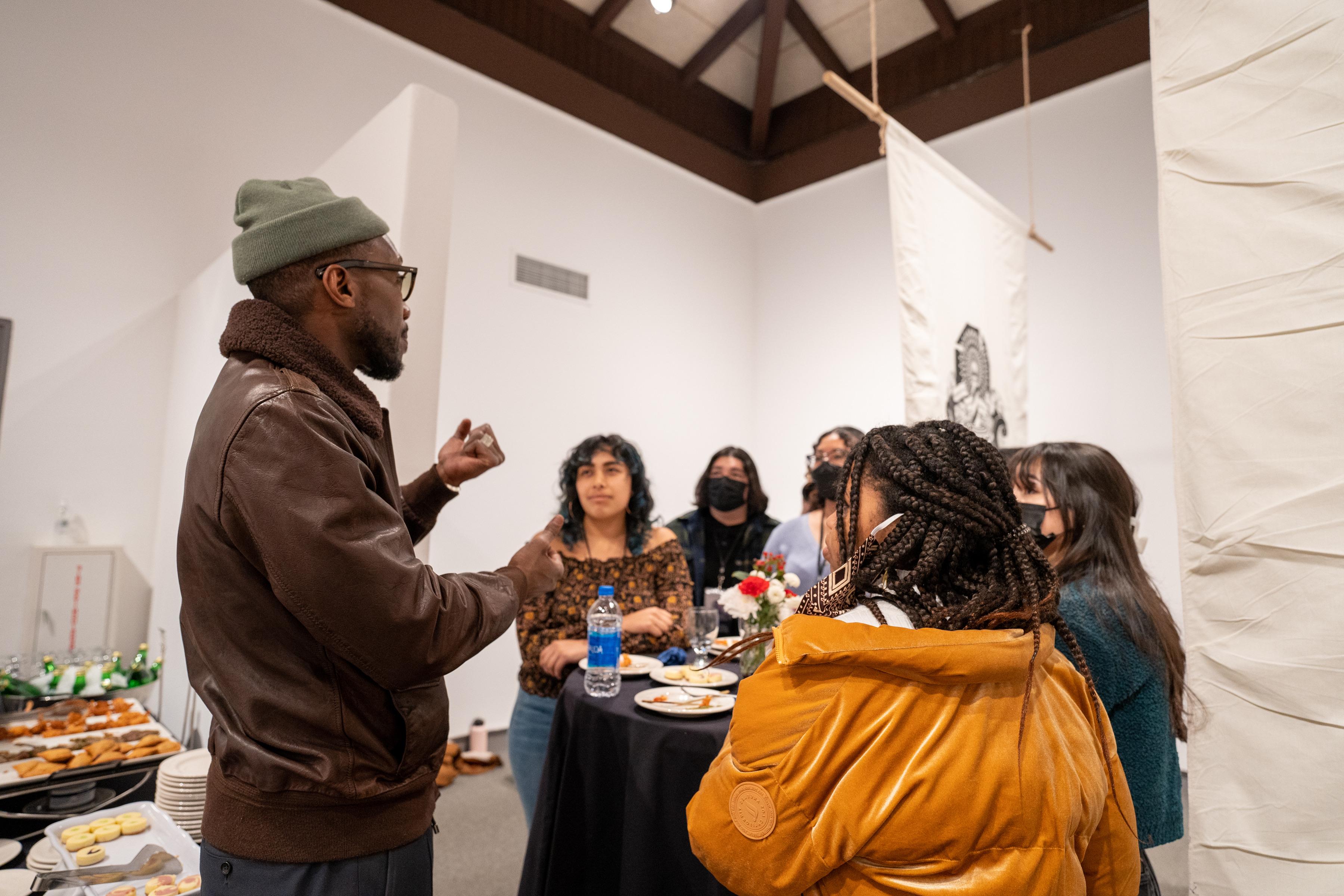 Mahershala Ali speaking to students in the museum