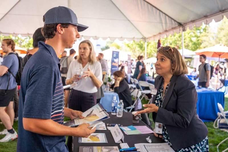 A student meeting with an employer at career fair