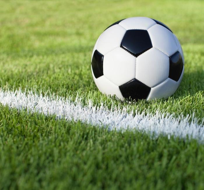 Soccer ball on grass with white stripe