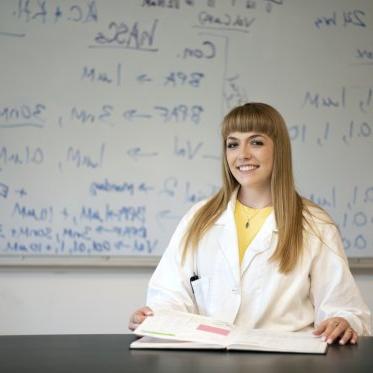 student in front of board