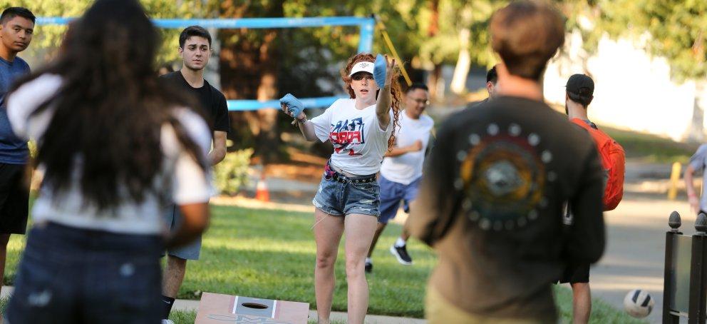 Students playing cornhole