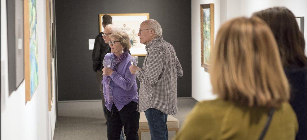 visitors in the galleries looking at art