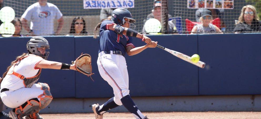 a softball player makes contact