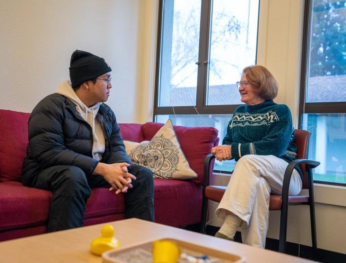 Success Coach and student having a discussion in office lounge